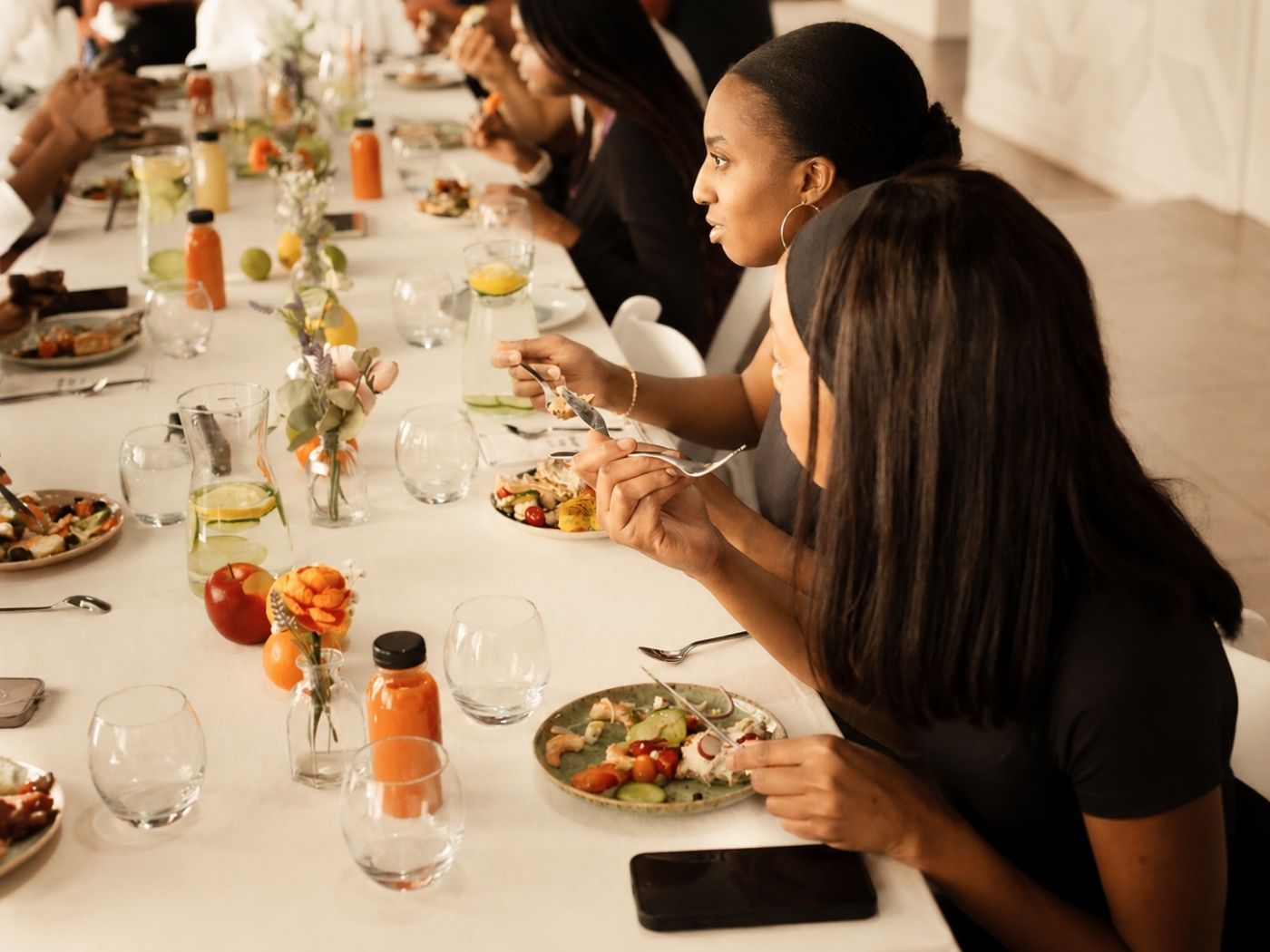 A group of women sitting around a table, deep in conversation